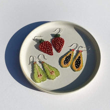 Load image into Gallery viewer, Three pairs of beaded fruit earrings on a plate: Jewel Strawberries, Yellow Papayas, and Green Anjou Pears.
